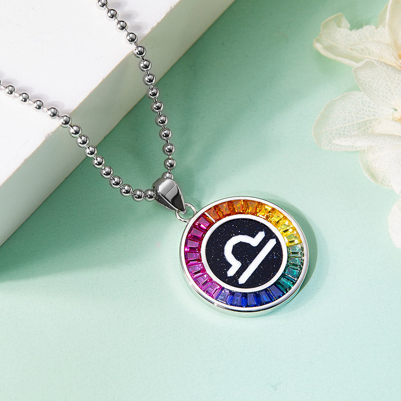 Necklace with a colorful libra zodiac pendant featuring a symbol on a light green background