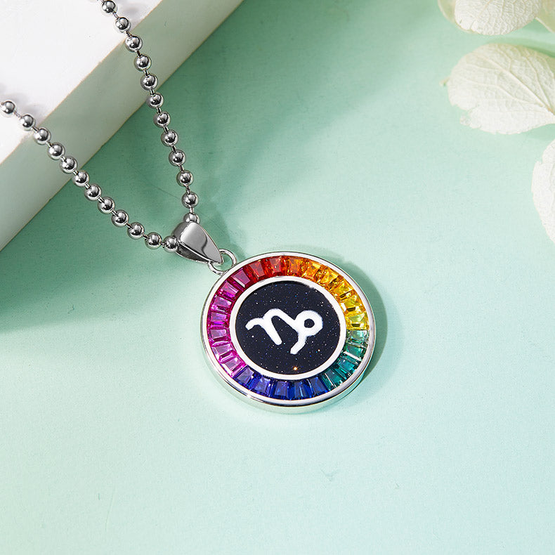 Necklace with a colorful Capricorn Zodiac pendant featuring a zodiac symbol on a light green background