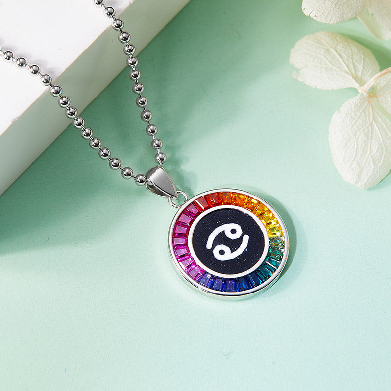 Necklace with a colorful cancer zodiac pendant on a light green background