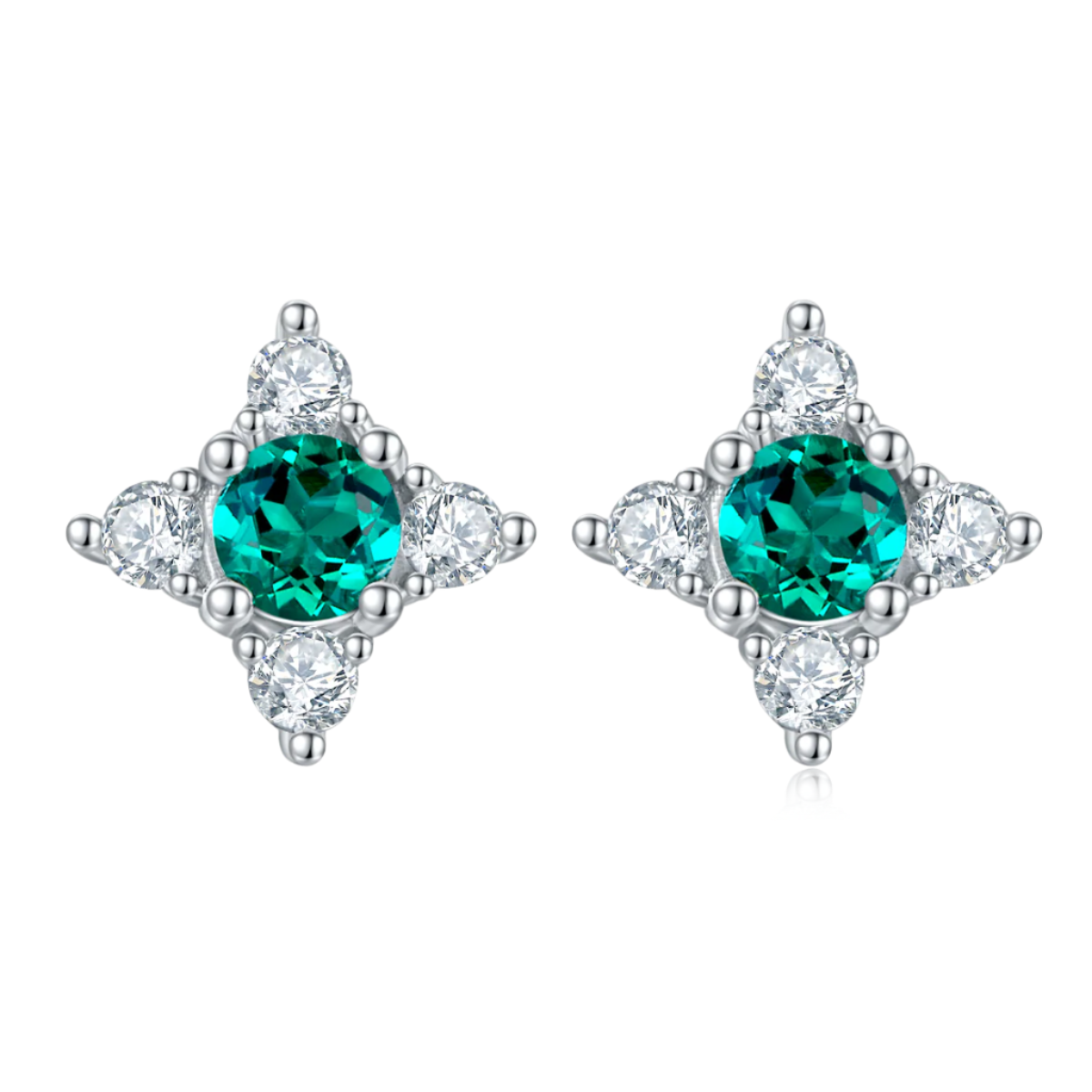 Pair of earrings with emerald gmstones and diamond-like stones on a white background
