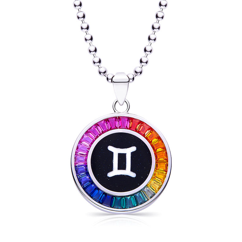 Necklace with a Gemini symbol pendant featuring rainbow-colored stones on a white background