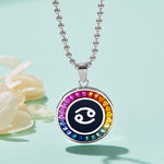 Necklace with a colorful cancer zodiac pendant on a light blue background