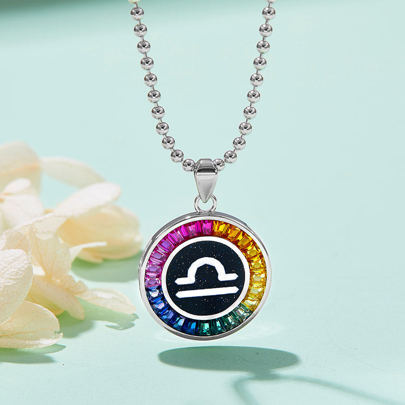Necklace with a colorful Libra zodiac pendant on a light green background