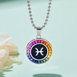Necklace with a colorful  Pisces zodiac pendant on a light blue background