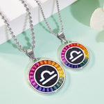 Two necklaces with rainbow-colored gemstones and astrological symbol on a light green background