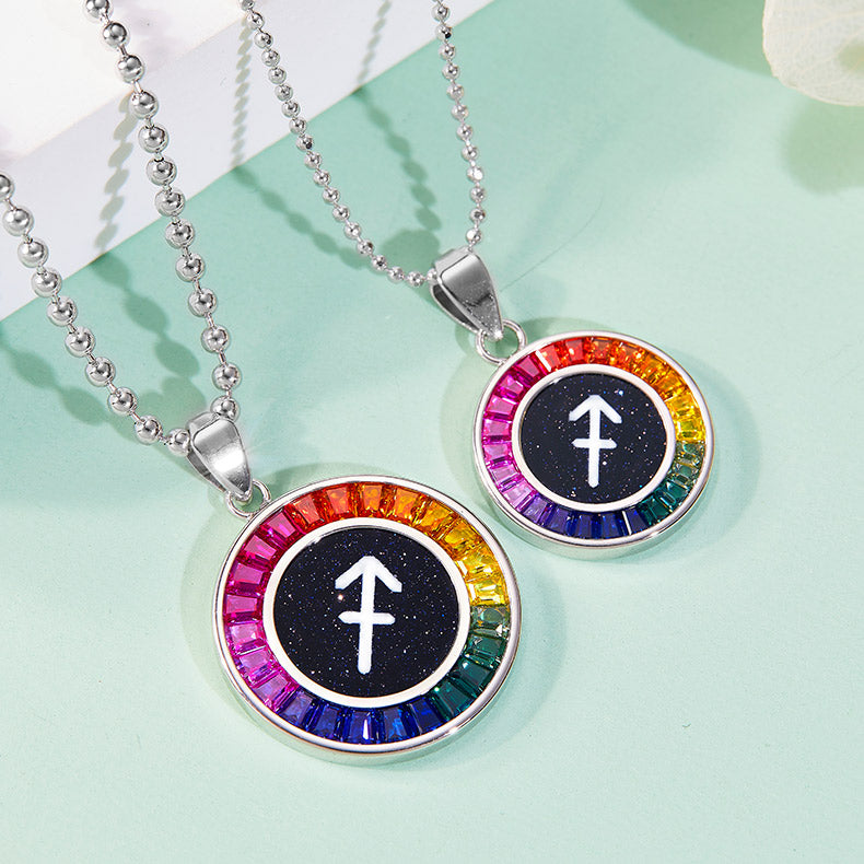 Two necklaces with colorful circular pendants featuring a symbol on a light green background.