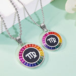 Two zodiac necklaces with colorful border and white symbol on a light green background