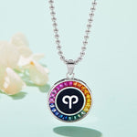 Necklace with a colorful pendant featuring a zodiac symbol on a light blue background