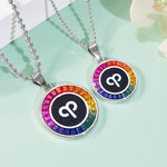 Two necklaces with aries zodiac symbol pendants on a light green background