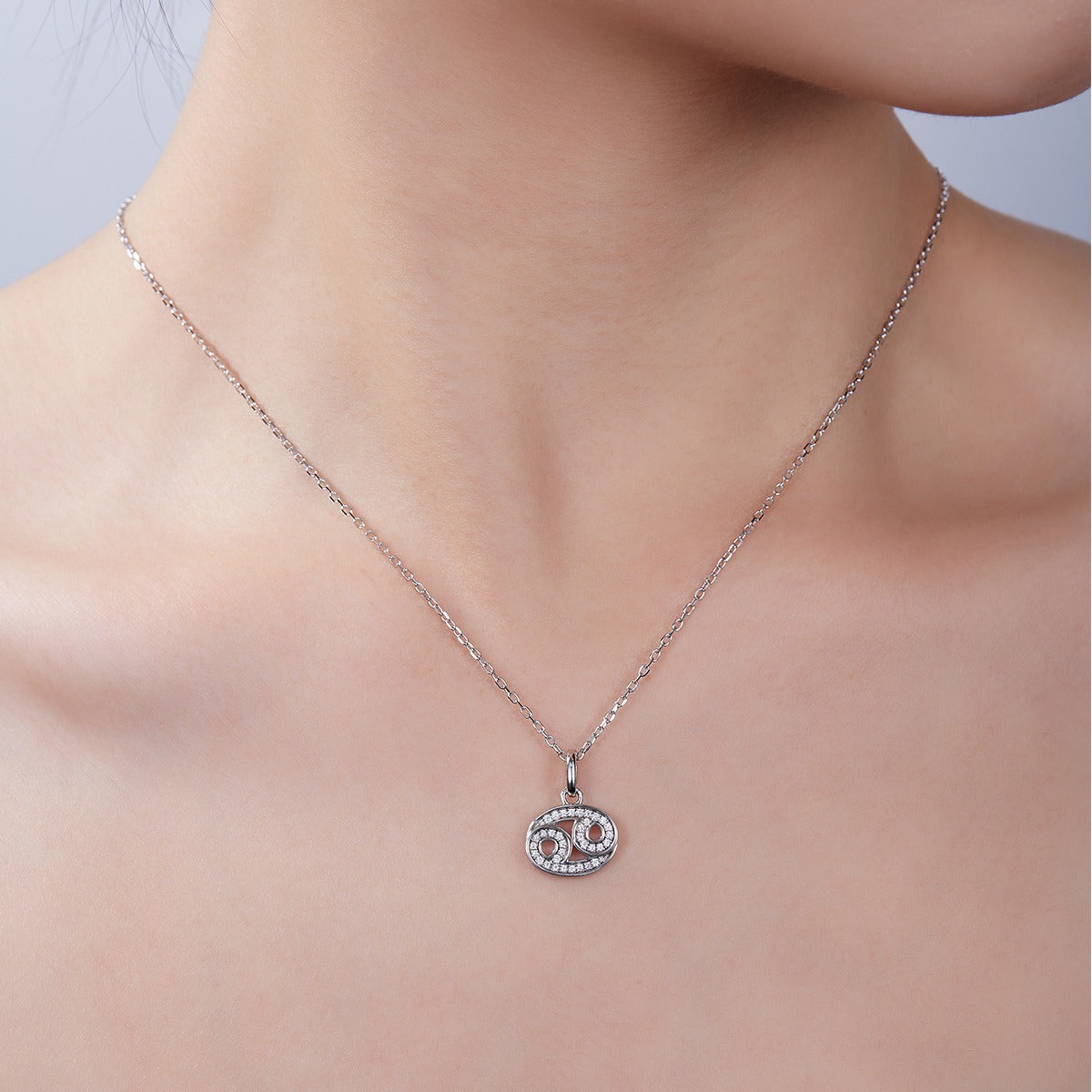 Necklace with a pendant on a model against a neutral background