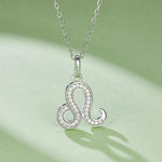 Silver 'S' pendant necklace on a light green background