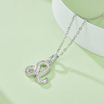 Silver snake-shaped pendant necklace on a light green background