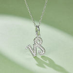 Silver necklace with a Capricorn zodiac pendant on a light green background