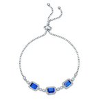 Silver bracelet with blue sapphire gemstones on a white background