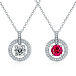 Two silver pendants with gemstones on a white background