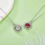 Two silver necklaces with gemstones on a green background