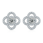 Pair of silver flower-shaped earrings with moissanite gemstones on a white background