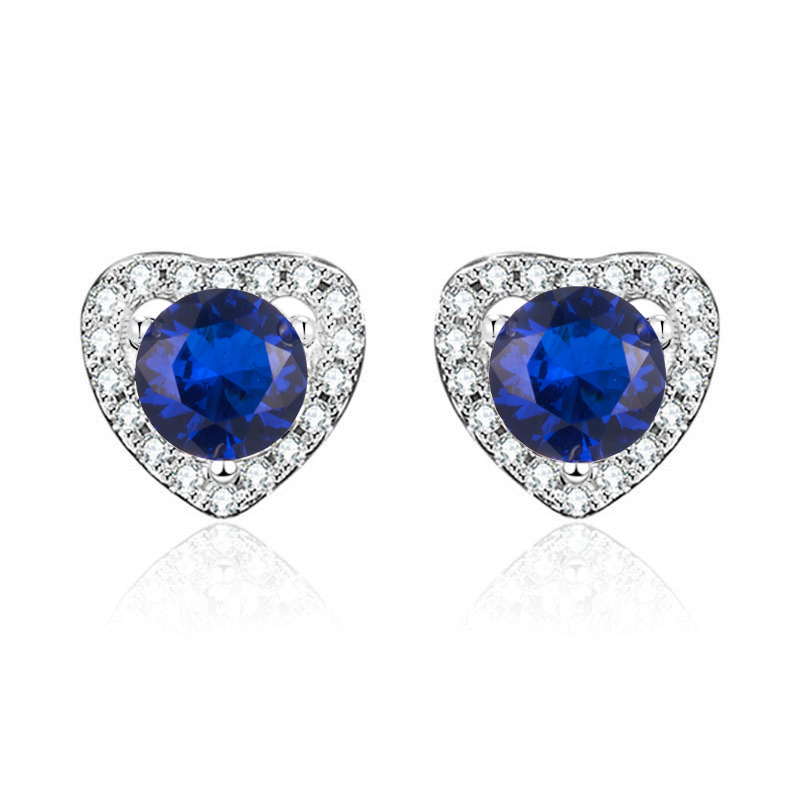 Heart-shaped earrings with blue gemstones and clear stones on a white background