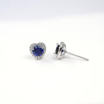 Heart-shaped blue gemstone earrings on a white background