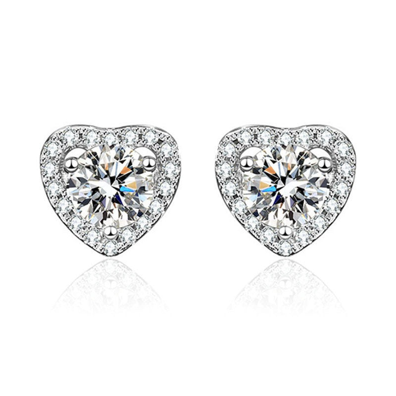 Heart-shaped earrings with clear gemstones on a white background