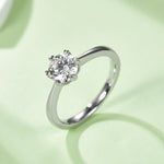 Round colorless moissanite solitaire angled view
