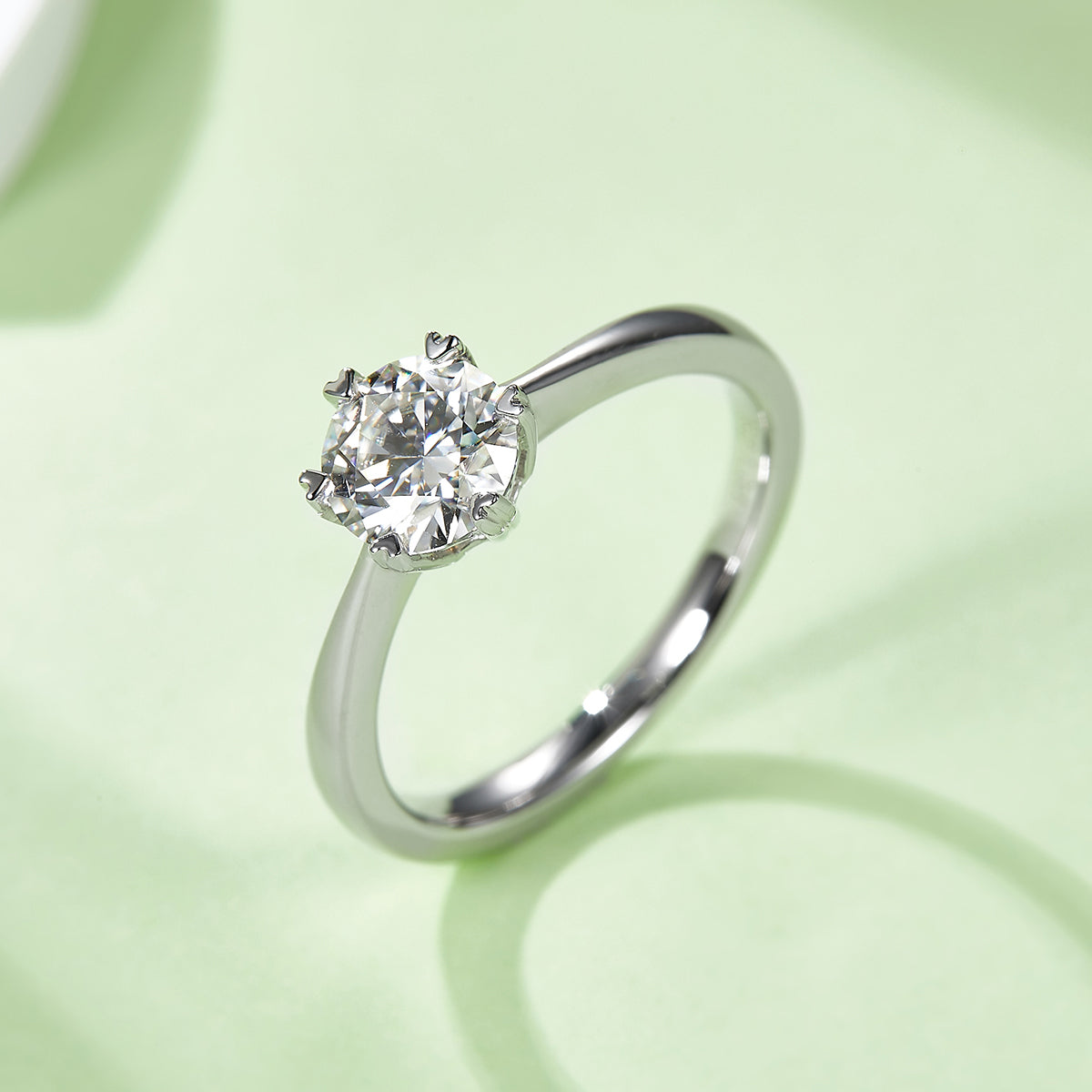 Round colorless moissanite solitaire angled view