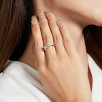 Round colorless moissanite solitaire shown on hand