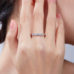 Round moissanite band shown on hand
