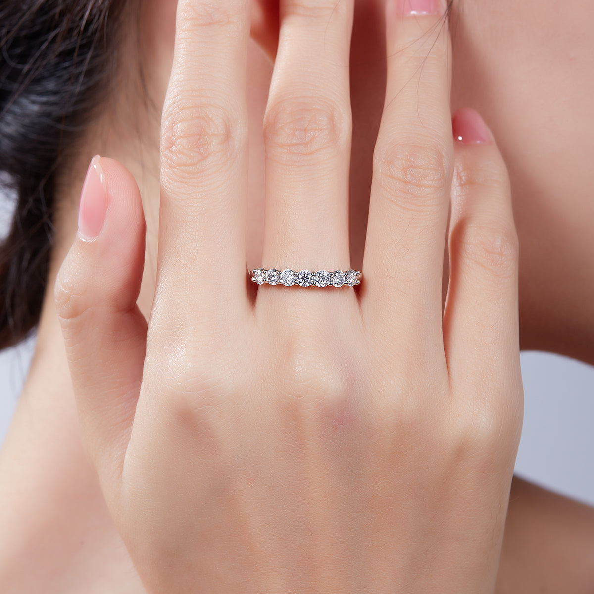 Round moissanite band shown on hand