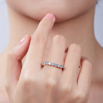 Round moissanite band angled on-hand view