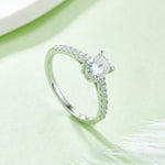 Oval pave ring angled view on pale green background