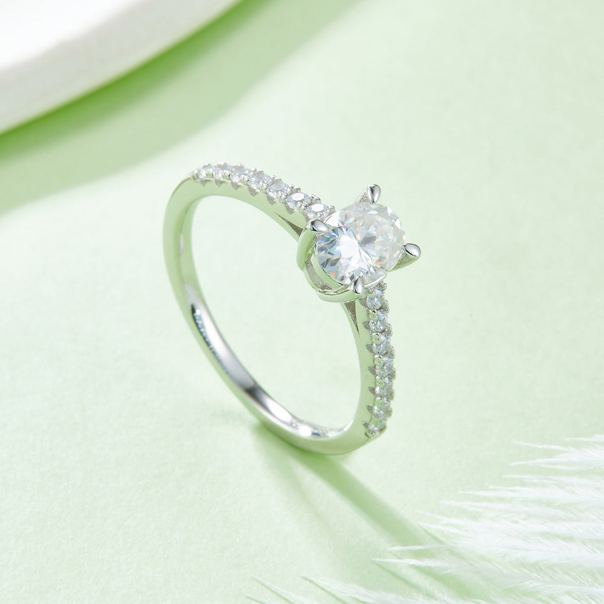 Oval pave ring angled view on pale green background