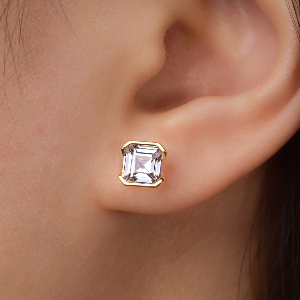 Asscher-cut yellow gold-plated stud shown on ear