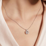 Moissanite floating pendant shown worn on a model