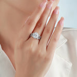 Oval moissanite floral ring shown on hand