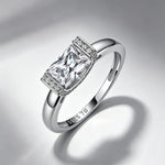 Radiant-cut moissanite engagement ring on a soft shadow background