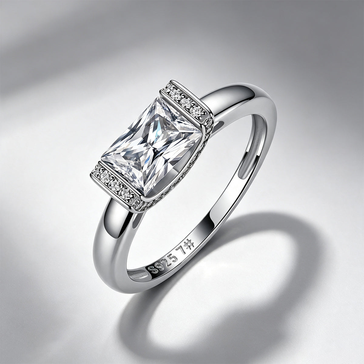 Radiant-cut moissanite engagement ring on a soft shadow background